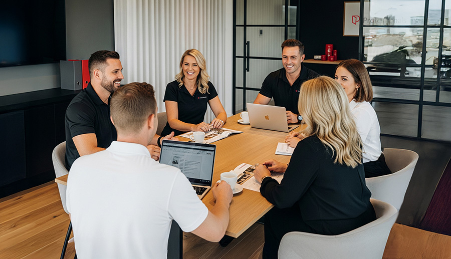 Sales agents attending meeting in boardroom
